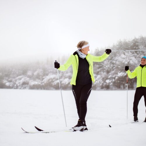 senior-couple-cross-country-skiing-PFPW3AQ-scaled